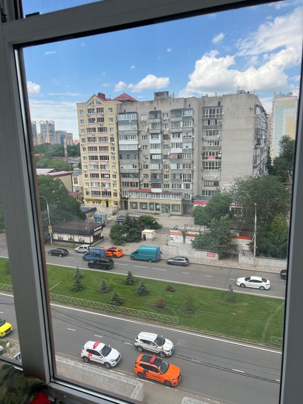 Art supplies and city views from a window-side workspace
