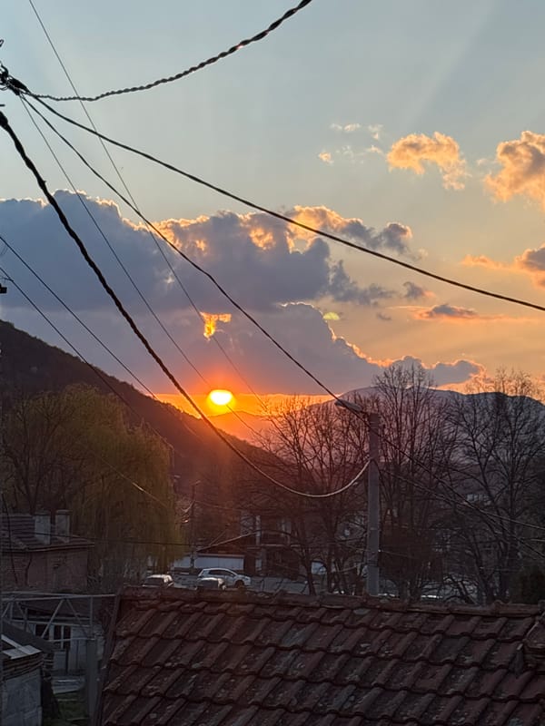 Day-to-night transition captured in residential area with sunset, streetlights