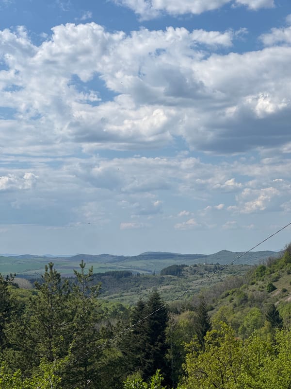 Observer documents cloud formations over Bulgarian countryside landscape