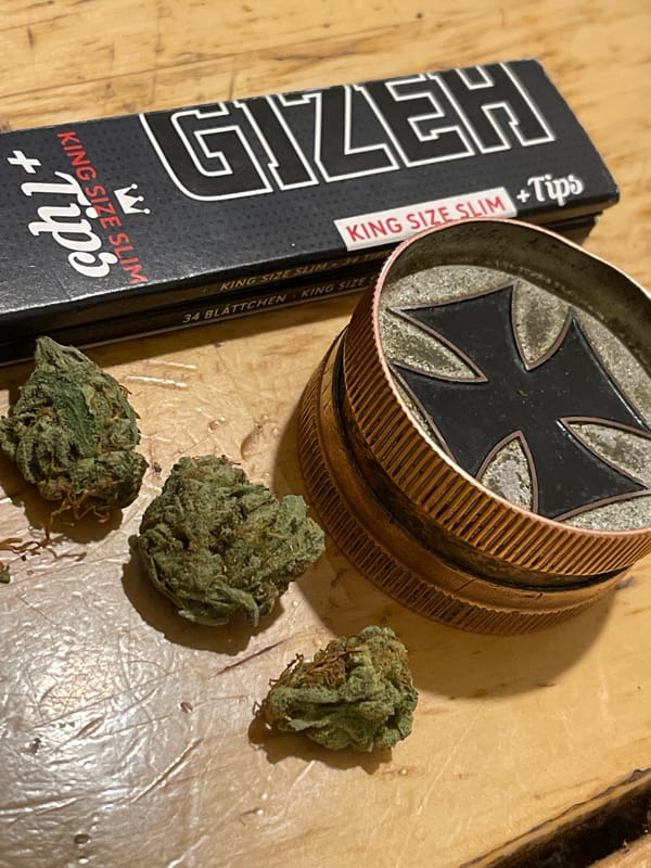 Cannabis preparation materials and young male documented indoors