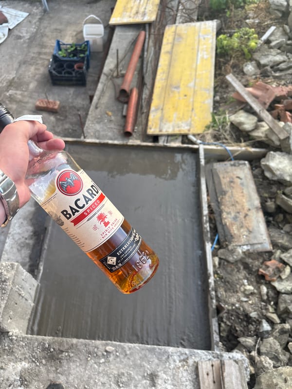 Person drinks Bacardi rum at construction site
