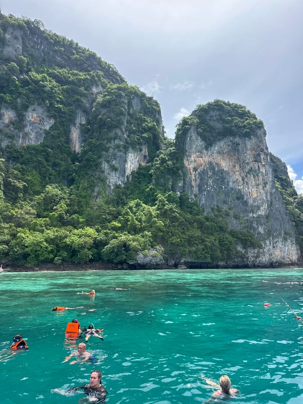 Snorkeling and boats at Ao Nang's limestone cliffs
