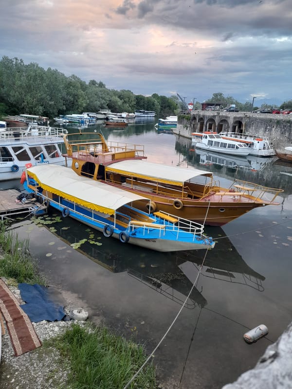 Mixed fleet of boats docked at waterfront quay
