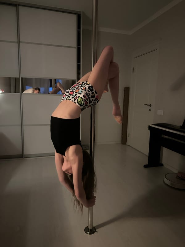 Woman performs pole dancing routine in Tomilino home