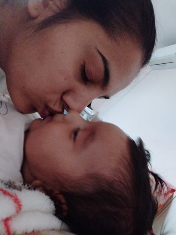 Woman shares tender moments with baby in intimate photo session