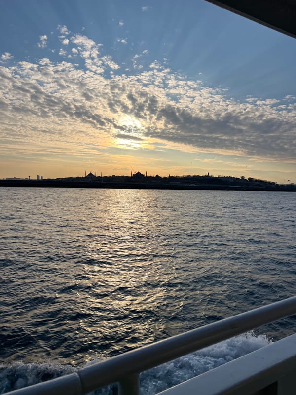 Sunset illuminates Üsküdar skyline with mosques silhouetted against golden sky