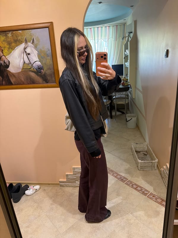 Woman and girl take mirror selfies in Kamyshin room