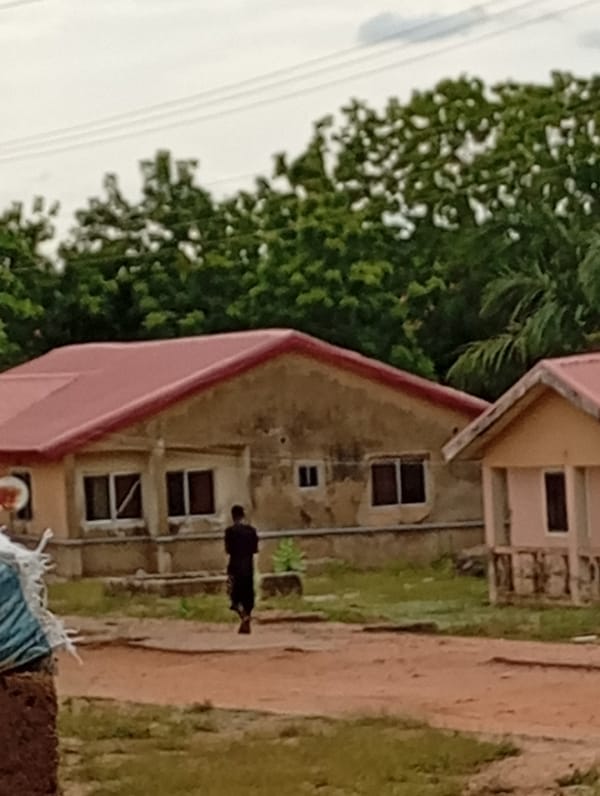 Rural compound shows everyday life, motorcycle traffic