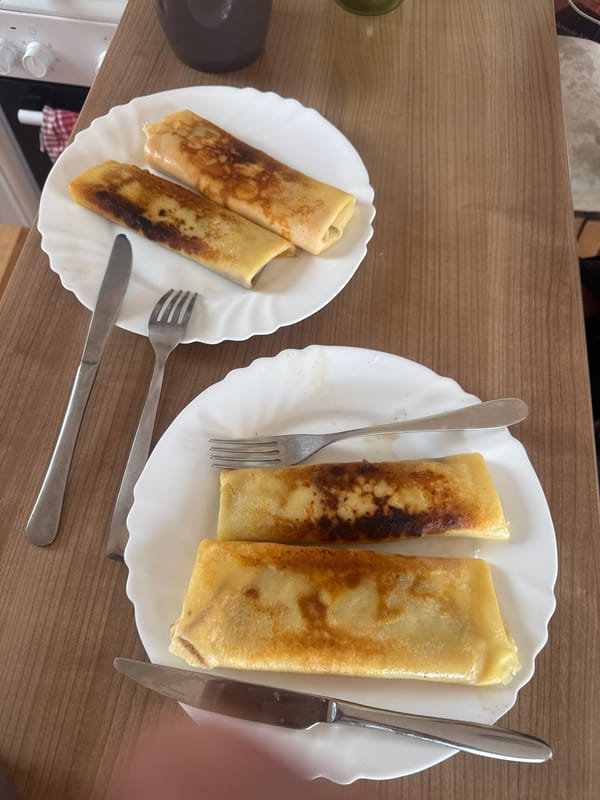 Morning crepes served on wooden table, witness documents breakfast