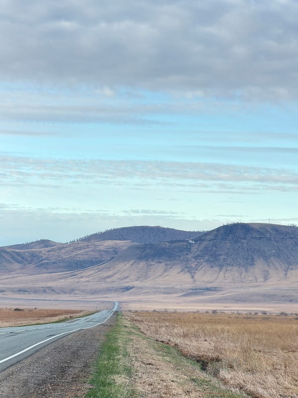 Gray car parked on rural road shoulder near Aeshka