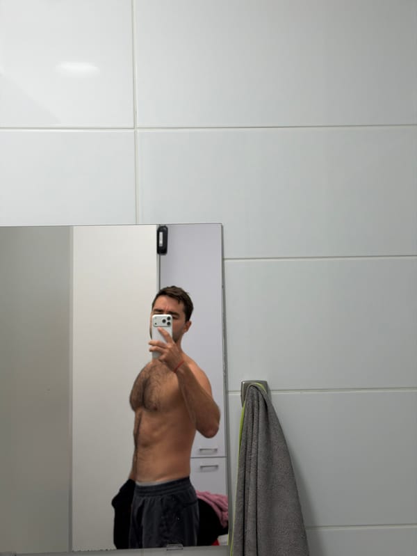 Man takes shirtless mirror selfie in Tel Aviv indoor location