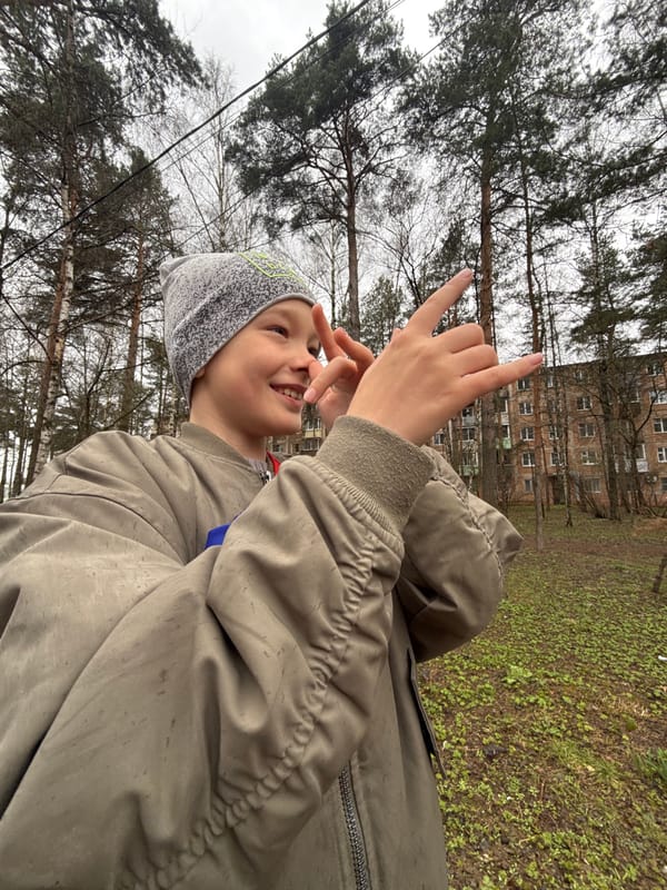 Young person poses with rock gesture in Dmitrov park