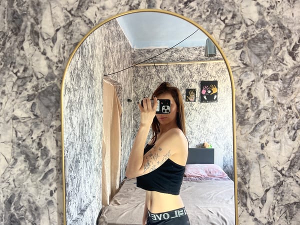 Woman takes mirror selfies in bedroom, Moldova