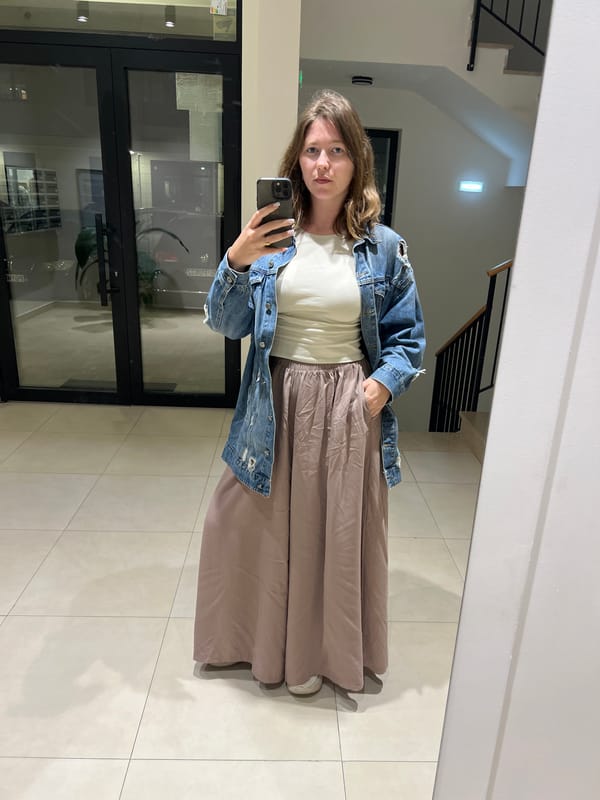 Woman takes mirror selfie in Podgorica building interior