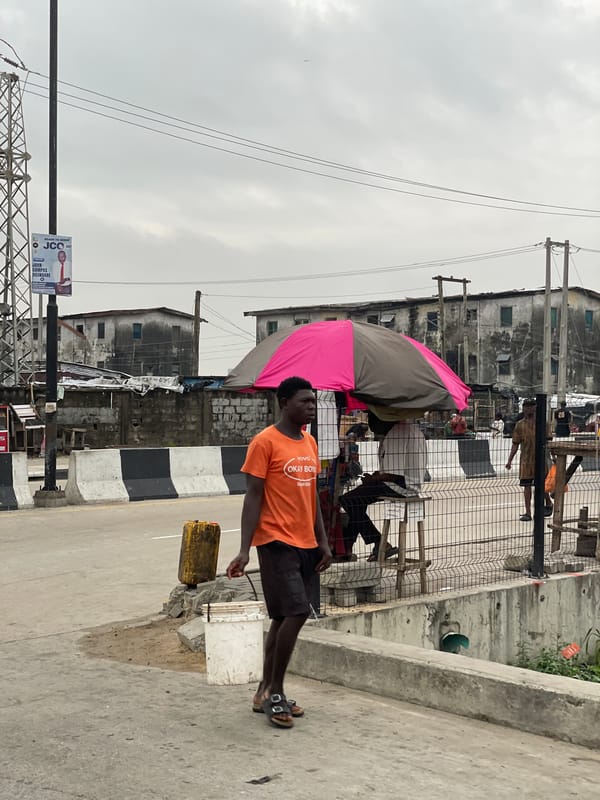 Street activity and church signage on a cloudy Igboefon morning