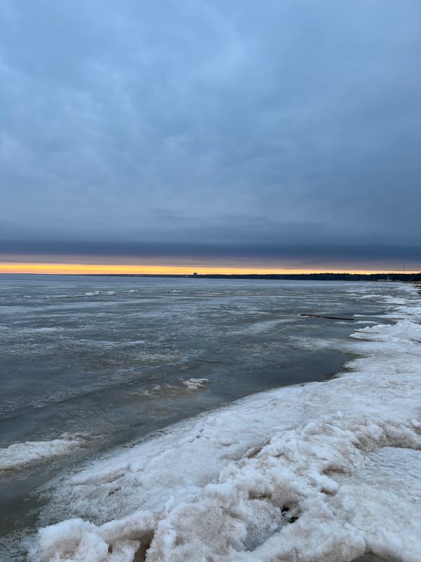 Nordic walker exercises on frozen Russian coastline