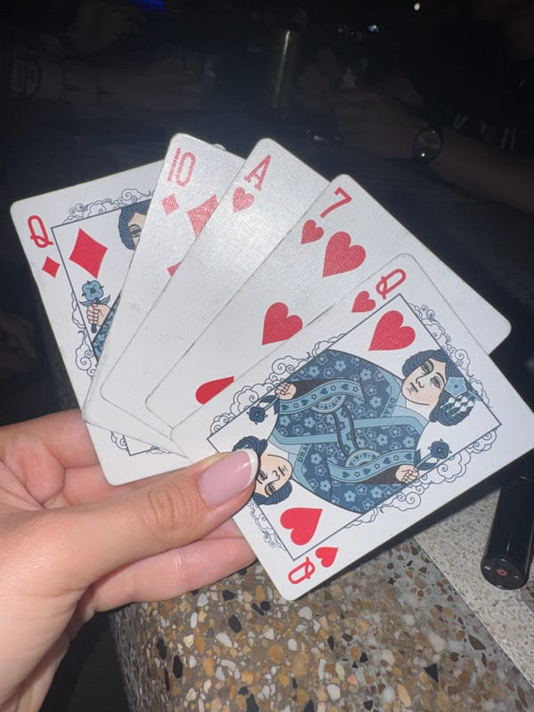 Late-night card game in a Ruse park, summer evening.