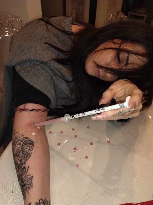 Woman self-administers injection in Crauthem, Luxembourg residence