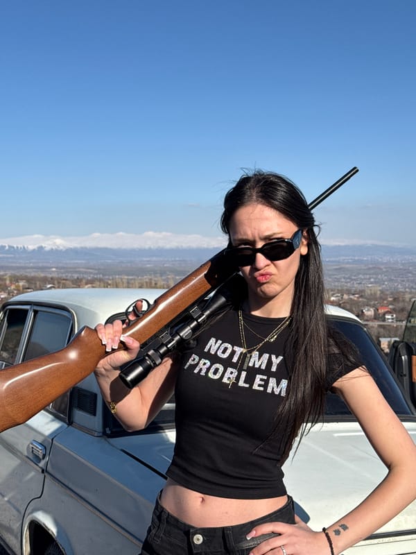 Woman photographed with rifle, dog in Byurakan Armenia