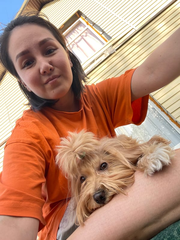 Woman with dog, cat on trampoline in Russian village