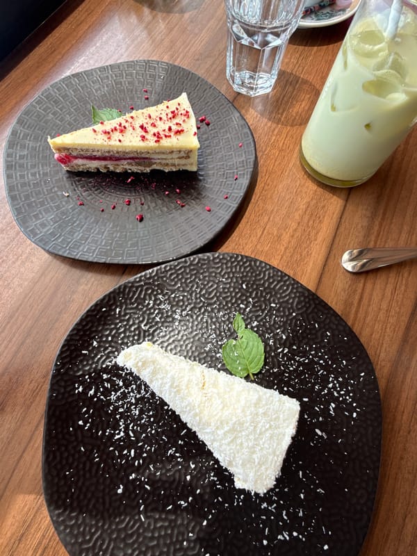 Layered cake slices with berry garnish on a Varna table