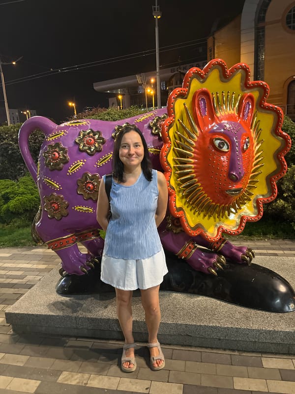 Posing with bold animal sculptures outside a Kyiv venue