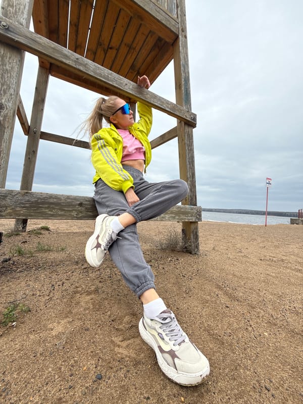 Woman enjoys solitary morning at Chaikovsky beach under grey skies