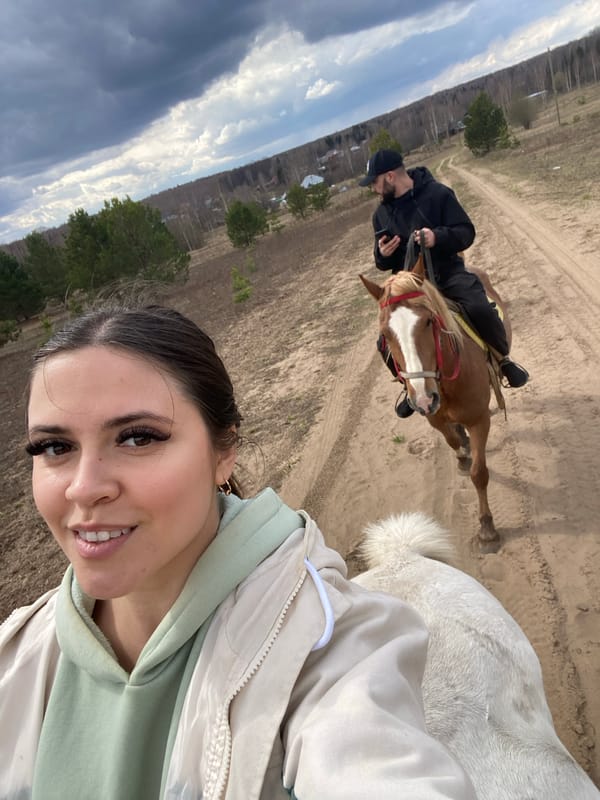 Horseback riders documented during morning trail ride in rural Russia