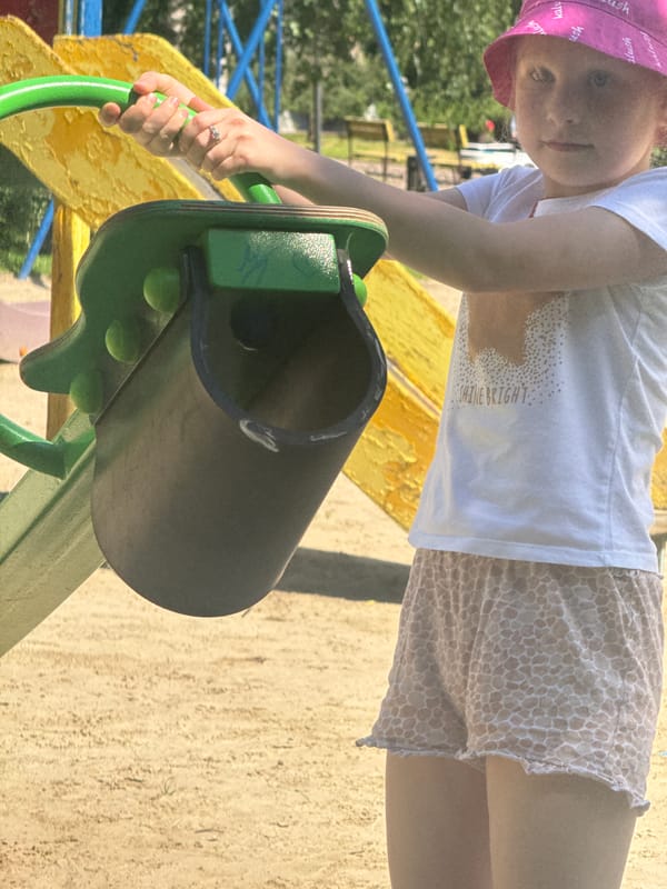 Children play at Poltava playground during sunny afternoon