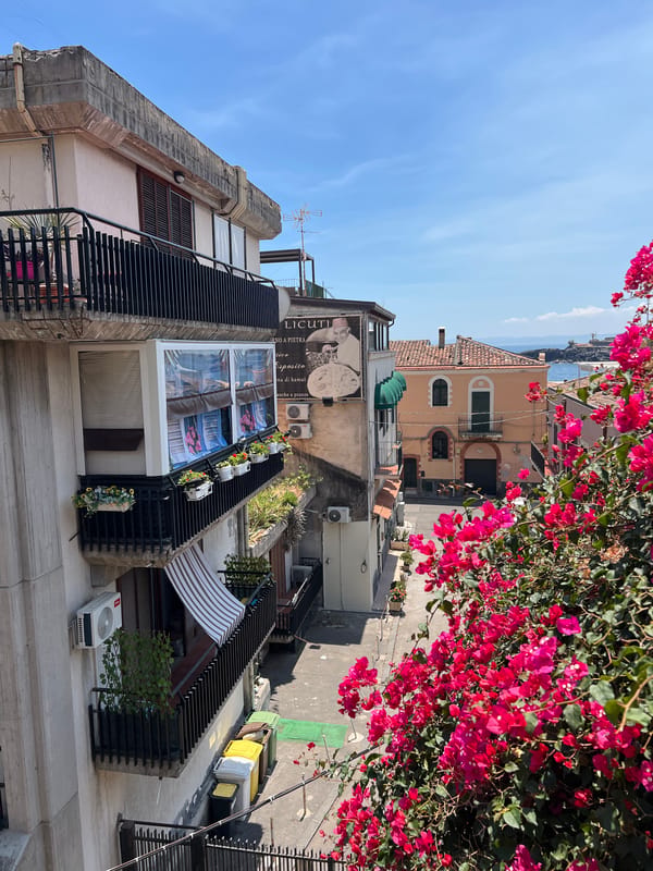 Rooftop views over Catania's streets and the Sicilian coast