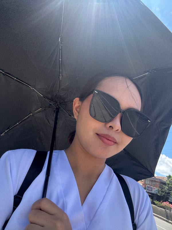 Person with umbrella and sunglasses photographed in Davao City