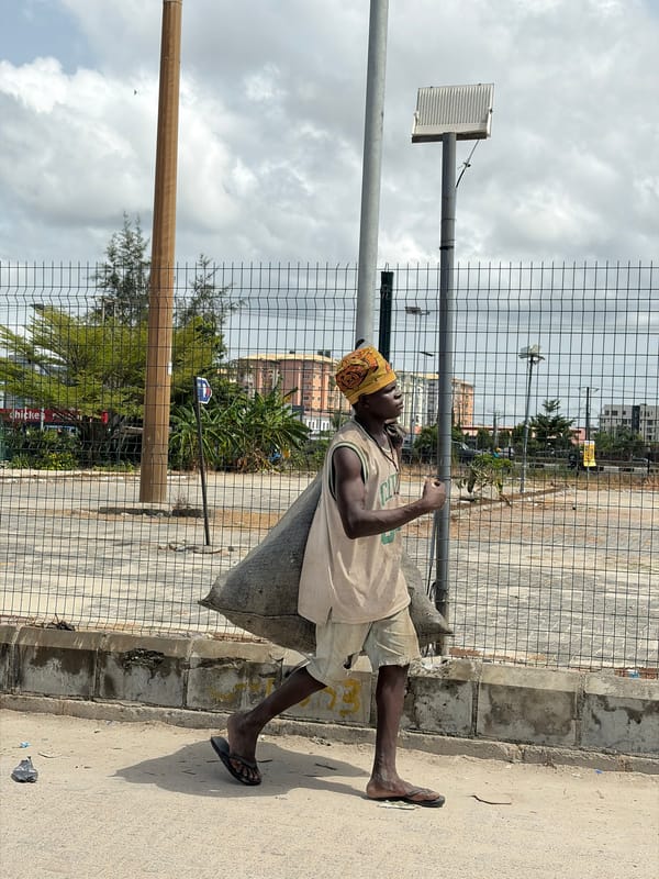 Man sits by fence in Igboefon, Nigeria