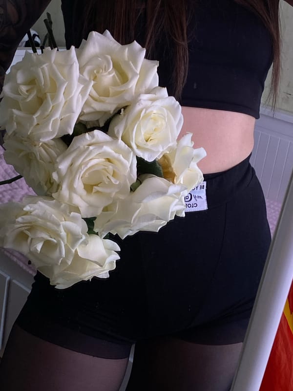 Person photographed with white roses in Votkinsk, Russia
