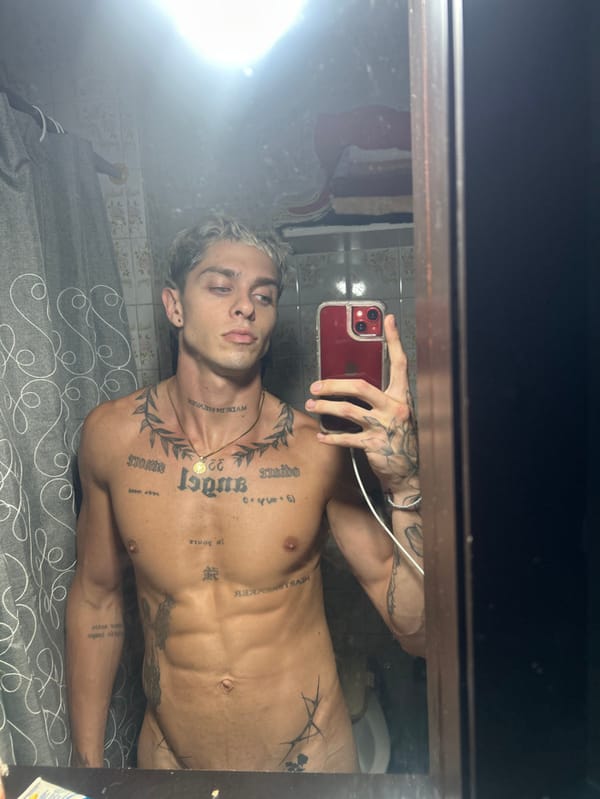Tattooed man takes mirror selfie in Buenos Aires