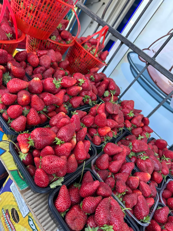 Fresh strawberries displayed at outdoor market in Ақсу, Kazakhstan