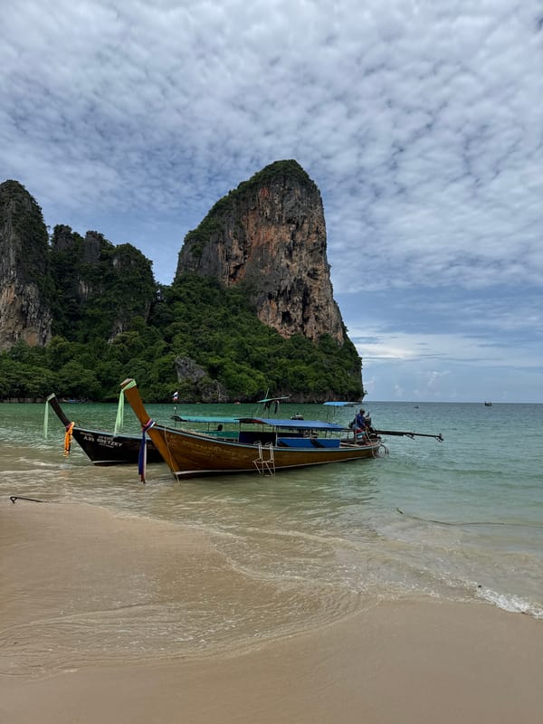 Longtail boats and limestone cliffs at Ao Nang beach
