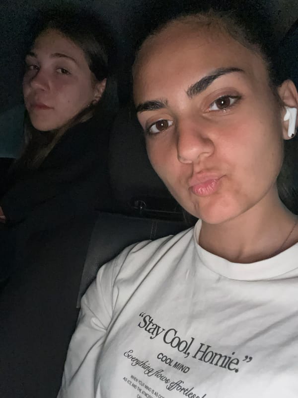 Young women take selfies in car during evening hangout