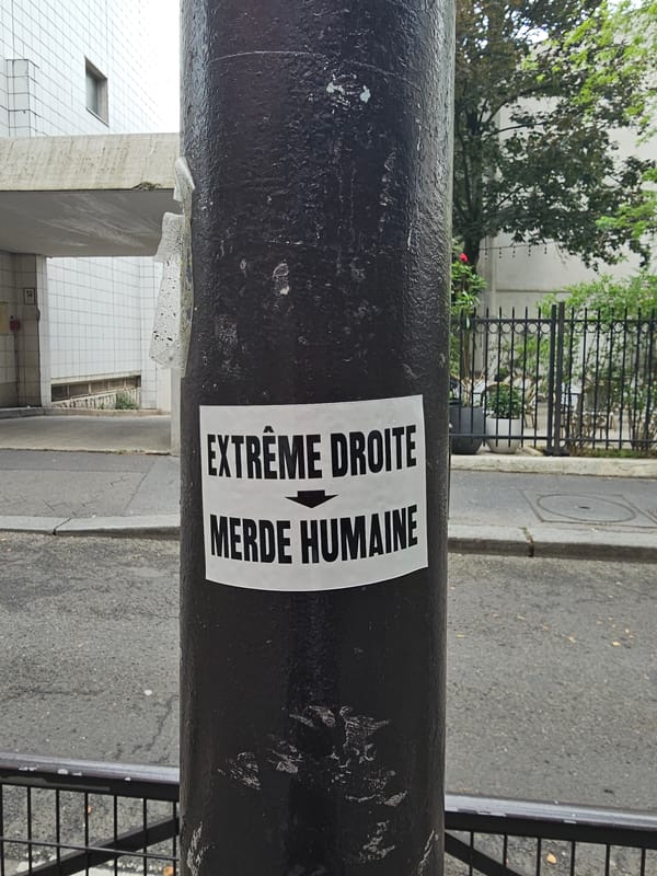 Political sticker spotted on Paris street bollard