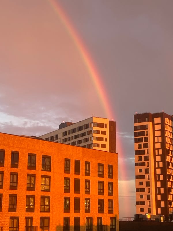 Rainbow and golden sunset over Moscow high-rises