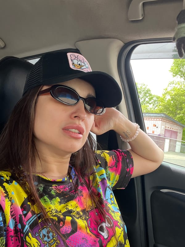 Woman rests in car with open sunroof during early morning
