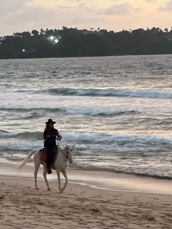 Horseback riding along Choeng Thale beach at golden hour