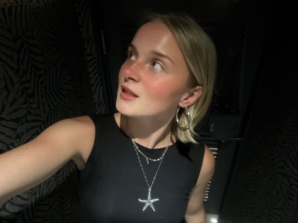 Woman takes selfie wearing starfish jewelry in Vancouver