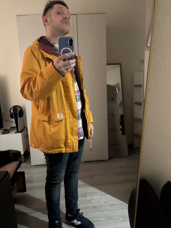 Man takes mirror selfie in yellow jacket, Saint Petersburg