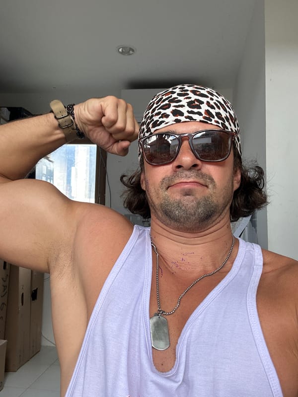 Flexing in leopard print bandana and light purple tank top