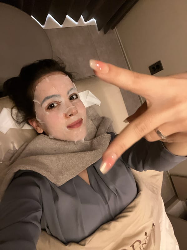 Person makes peace sign while resting in bed in Seoul