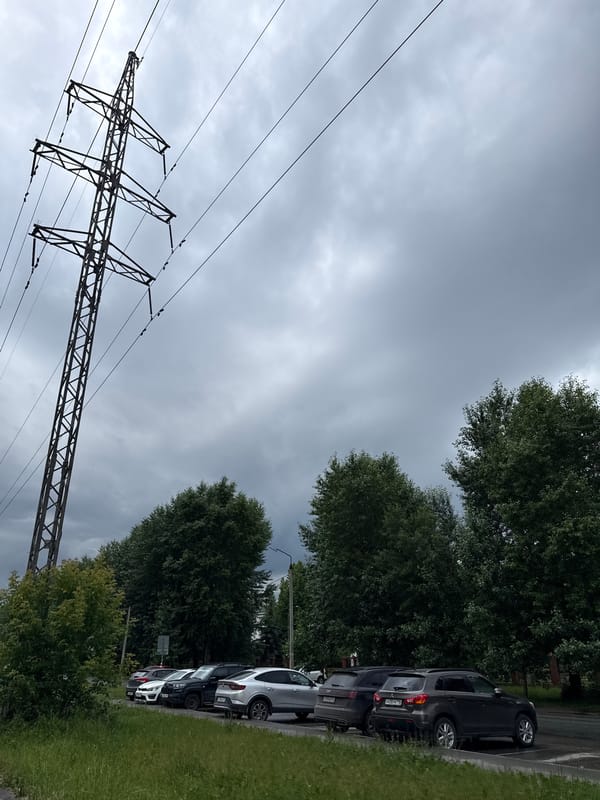 Power pylons and utility lines under a cloudy sky