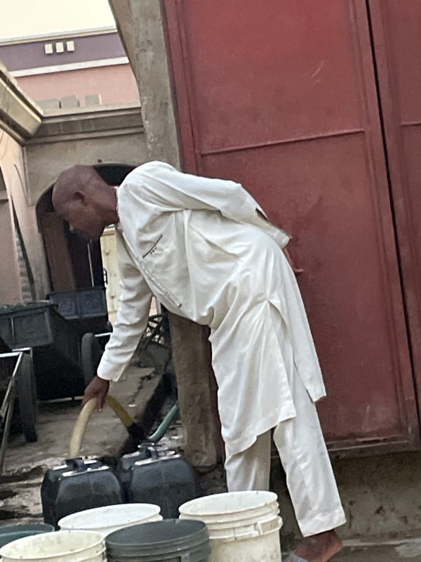 Early morning liquid distribution operation documented in urban alleyway