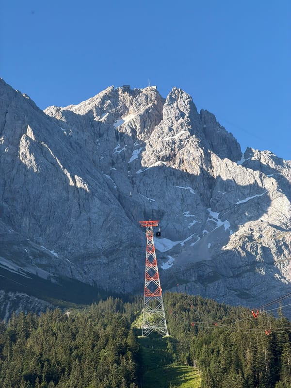 Cable car tower under blue skies in the Bavarian Alps