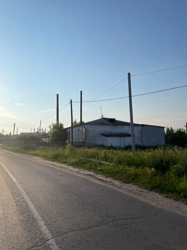 Drive through rural Russian village reveals mixed residential and industrial scenes