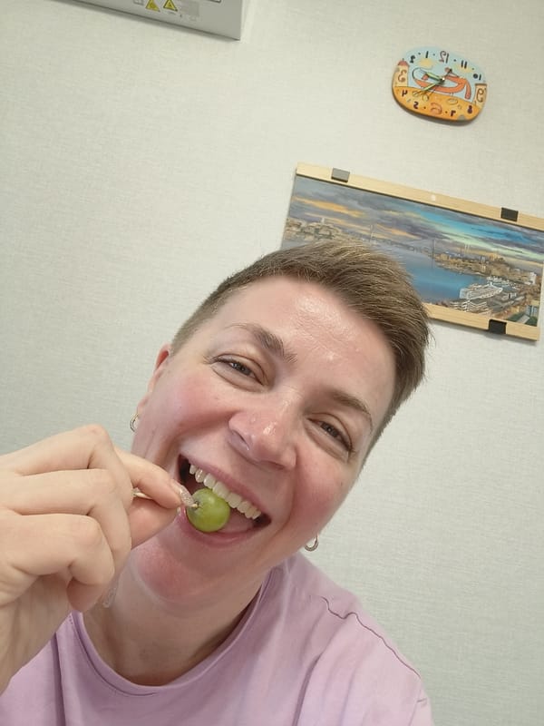 Woman enjoys grape snack in Saint Petersburg guilty pleasures moment